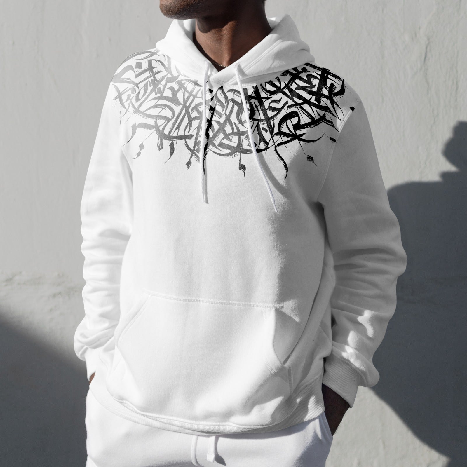 Elevate your style with the Guldasta - A Garland for the neck. This classic sweatshirt boasts stunning Arabic calligraphy and Islamic art, creating a truly unique and meaningful design. Complete with a front pouch pocket and matching drawstrings, it's the perfect gift for any occasion. Add a touch of culture to your wardrobe today.